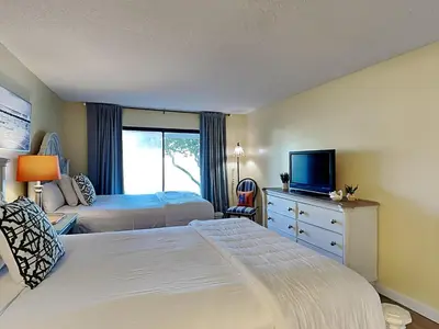a hotel room with two beds and a television at Edgewater Villa #2007 in Panama City Beach