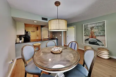 a kitchen and dining room with a table and chairs at Edgewater Villa #2007 in Panama City Beach