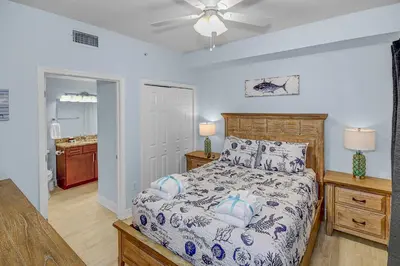 a bedroom with a bed and a ceiling fan at 1BD/2BA Unit w/ a bunk alcove and amazing views right on the GULF! in Panama City Beach