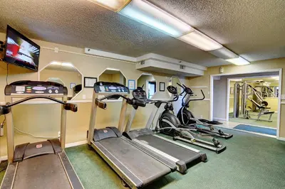 a gym with three treadmills and a treadmill at Summit Beach Resort #1102 in Panama City Beach