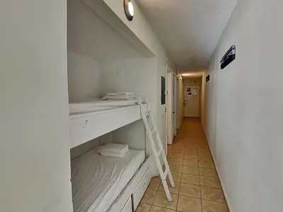 a hallway with a shelf and a ladder in a room at Summit Beach Resort #1102 in Panama City Beach