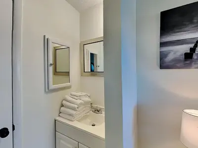a bathroom with a sink and two mirrors at Summit Beach Resort #1102 in Panama City Beach