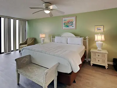 a bedroom with a large bed with a ceiling fan at Edgewater Tower Ii 510 in Panama City Beach