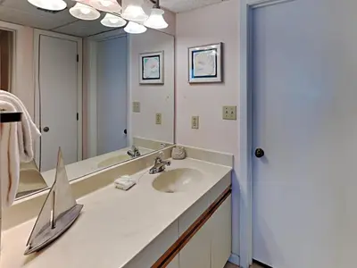 a bathroom with a sink and a large mirror at Edgewater Tower Ii 510 in Panama City Beach