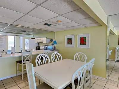 a dining room with a white table and chairs at Edgewater Tower Ii 510 in Panama City Beach