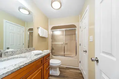 a bathroom with a toilet and a sink and a shower at Edgewater Villa #2112 in Panama City Beach