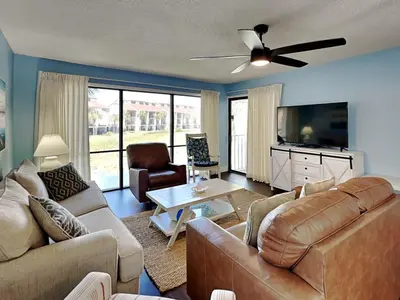 a living room with couches and a ceiling fan at Edgewater Villa #407 in Panama City Beach