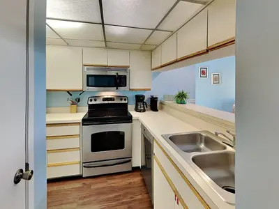 a kitchen with a stove and a sink at Edgewater Villa #407 in Panama City Beach