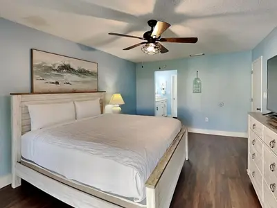 a bedroom with a bed and a ceiling fan at Edgewater Villa #407 in Panama City Beach
