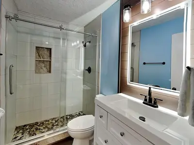 a bathroom with a toilet and a sink and a shower at Edgewater Villa #407 in Panama City Beach