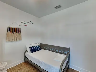 a bedroom with a bed in a white wall at Sun Kissed Memories in Panama City Beach