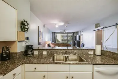 a kitchen with a sink and a counter top at Shores of Panama 328 - Low Floor HUGE 3 BedroomBunk Room, Reserved Parking, condo in Panama City Beach