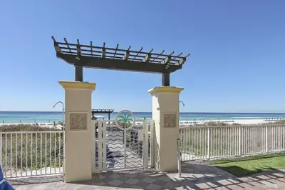a gate at the beach with the ocean in the background at Shores of Panama 328 - Low Floor HUGE 3 BedroomBunk Room, Reserved Parking, condo in Panama City Beach