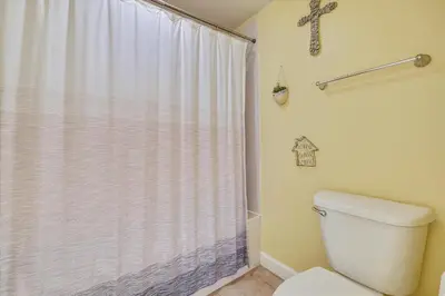 a bathroom with a toilet and a shower curtain at Shores of Panama 328 - Low Floor HUGE 3 BedroomBunk Room, Reserved Parking, condo in Panama City Beach