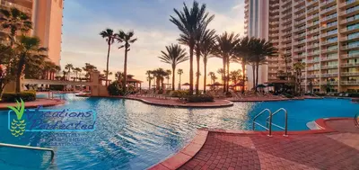 a large swimming pool with palm trees and buildings at Shores of Panama 2025 - 1 Bedroom Bunks Sleeps 6, Reserved Parking, Free Fun! condo in Panama City Beach