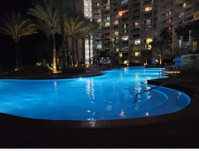 a large pool with blue water at night at Shores of Panama 2327 - 1 BedroomBunks and Sleeper Sofa, Sunset View! Free Fun! condo in Panama City Beach