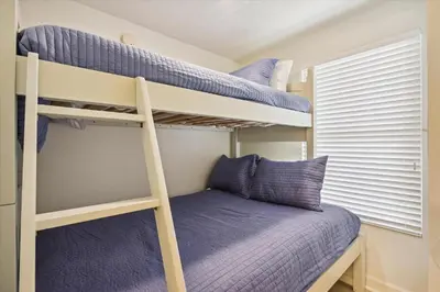 a bedroom with two bunk beds and a window at Shores of Panama 1717 - 1 Bedroom Bunk room Sleeps 6, Gulf-Front with Oversized Balcony! condo in Panama City Beach