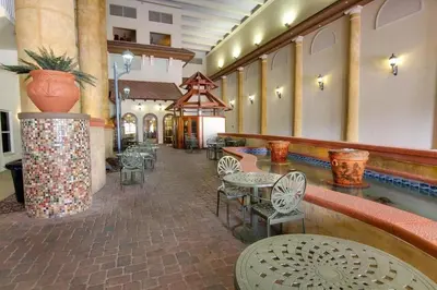 a lobby with tables and chairs and a pool at Shores of Panama 2026 - 1 BedroomBunksSleeps 6, Res, Parking! condo in Panama City Beach