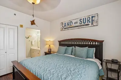 a bedroom with a bed and a sign on the wall at Shores of Panama 1418 - 2 BedroomBunkroom Sleeps8! Updated with a View! Free Fun! condo in Panama City Beach