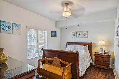 a bedroom with a bed and a desk and a chair at Shores of Panama 1418 - 2 BedroomBunkroom Sleeps8! Updated with a View! Free Fun! condo in Panama City Beach
