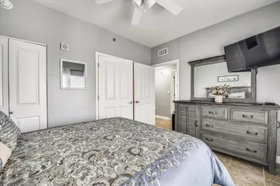 a bedroom with a bed and a dresser and a mirror at Shores of Panama 1704 - 2 Bedroom Bunk Room Sleeps 8, Updated! Res, Parking condo in Panama City Beach