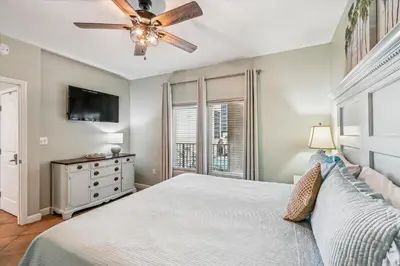 a bedroom with a bed and a ceiling fan at Shores of Panama 521 - 2 Bedroom Bunks Sleeps 6, Reserved Parking! condo in Panama City Beach