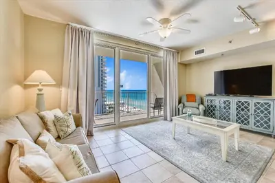 a living room with a couch and a table and a tv at Shores of Panama 808- 1 BedroomBunk Room, Free Fun! Updated! Sleeps 6, condo in Panama City Beach