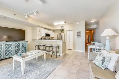 a living room with a couch and a table at Shores of Panama 808- 1 BedroomBunk Room, Free Fun! Updated! Sleeps 6, condo in Panama City Beach