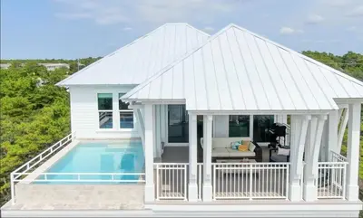 a house with a swimming pool and a porch at Beach Gulf Views with a 3rd Floor Pool - Mala House - Inlet Beach, FL home in Inlet Beach