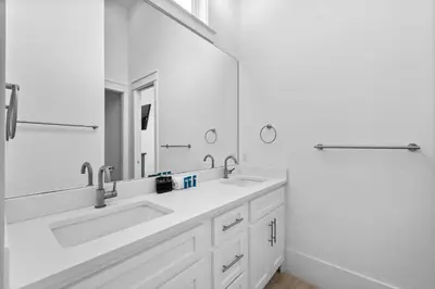 a bathroom with two sinks and a large mirror at Beach Gulf Views with a 3rd Floor Pool - Mala House - Inlet Beach, FL home in Inlet Beach