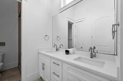 a white bathroom with two sinks and a mirror at Beach Gulf Views with a 3rd Floor Pool - Mala House - Inlet Beach, FL home in Inlet Beach