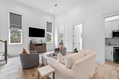 a living room with white furniture and a flat screen tv at Beach Gulf Views with a 3rd Floor Pool - Mala House - Inlet Beach, FL home in Inlet Beach