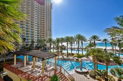 an aerial view of a resort with a pool and palm trees at Shores of Panama 314 - 1 BdBunks, Sleeps 6, Same Level Parking, Free Fun! condo in Panama City Beach