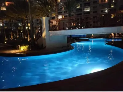 a large swimming pool at night with blue lights at Shores of Panama 314 - 1 BdBunks, Sleeps 6, Same Level Parking, Free Fun! condo in Panama City Beach