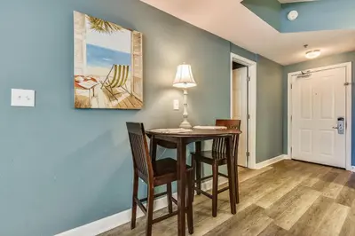 a dining room with a table and chairs at Shores of Panama 314 - 1 BdBunks, Sleeps 6, Same Level Parking, Free Fun! condo in Panama City Beach
