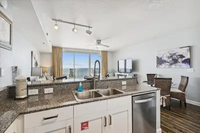 a kitchen with a sink and a large window at Shores of Panama 630-1BdBunks, Sleeps 6, Beach Front! Free Fun! Reserved Parking Space condo in Panama City Beach