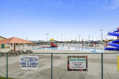 a view of a water park behind a fence at Shores of Panama 2330 - 1 Bedroom Bunk Area Sleeps 6, Beautiful Direct Beach View! Free Fun! condo in Panama City Beach