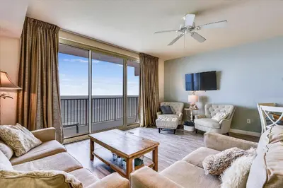 a living room with a couch and chairs and a balcony at Shores of Panama 2330 - 1 Bedroom Bunk Area Sleeps 6, Beautiful Direct Beach View! Free Fun! condo in Panama City Beach