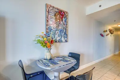 a table and chairs with a vase of flowers on it at Laketown Wharf 835 - Very Cool 1 BedroomBunks, Sleeps 6, Free Fun! condo in Panama City Beach