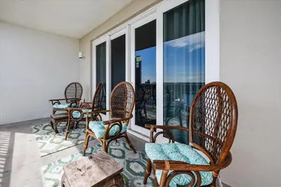 a group of chairs on a balcony with windows at Laketown Wharf 835 - Very Cool 1 BedroomBunks, Sleeps 6, Free Fun! condo in Panama City Beach