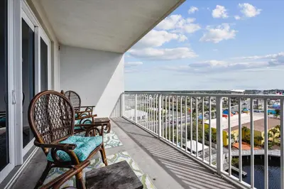 a balcony with chairs and a view of a parking lot at Laketown Wharf 835 - Very Cool 1 BedroomBunks, Sleeps 6, Free Fun! condo in Panama City Beach