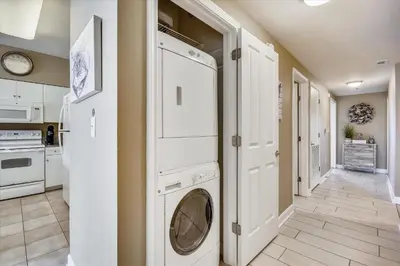 a laundry room with a washer and dryer at Shores of Panama 1804 - 2 Bedroom Bunkroom Sleeps 8, Updated! Free Fun, condo in Panama City Beach