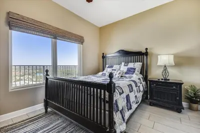 a bedroom with a bed and a large window at Shores of Panama 1804 - 2 Bedroom Bunkroom Sleeps 8, Updated! Free Fun, condo in Panama City Beach