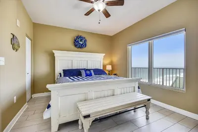 a bedroom with a bed with a ceiling fan and a window at Shores of Panama 1804 - 2 Bedroom Bunkroom Sleeps 8, Updated! Free Fun, condo in Panama City Beach