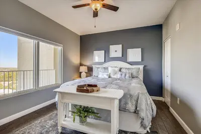 a bedroom with a bed and a ceiling fan at Shores of Panama 1807 -Fantastic 2BdBunks, Sleeps 8! Reserved Parking! Free Fun condo in Panama City Beach