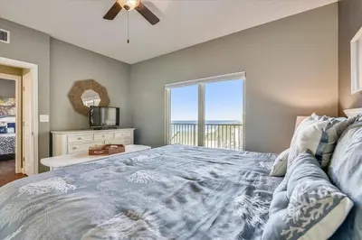 a bedroom with a bed with a view of the ocean at Shores of Panama 1807 -Fantastic 2BdBunks, Sleeps 8! Reserved Parking! Free Fun condo in Panama City Beach