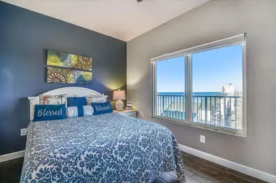 a bedroom with a bed and a large window at Shores of Panama 1807 -Fantastic 2BdBunks, Sleeps 8! Reserved Parking! Free Fun condo in Panama City Beach