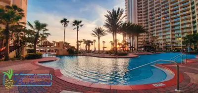 a large swimming pool with palm trees and buildings at Shores of Panama 1807 -Fantastic 2BdBunks, Sleeps 8! Reserved Parking! Free Fun condo in Panama City Beach