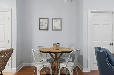 a dining room with a wooden table and chairs at Happy Days - Seagrove Highlands in Santa Rosa Beach