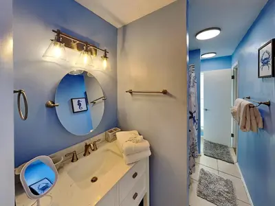 a bathroom with a sink and a mirror at Endless Summer #A27 in Panama City Beach